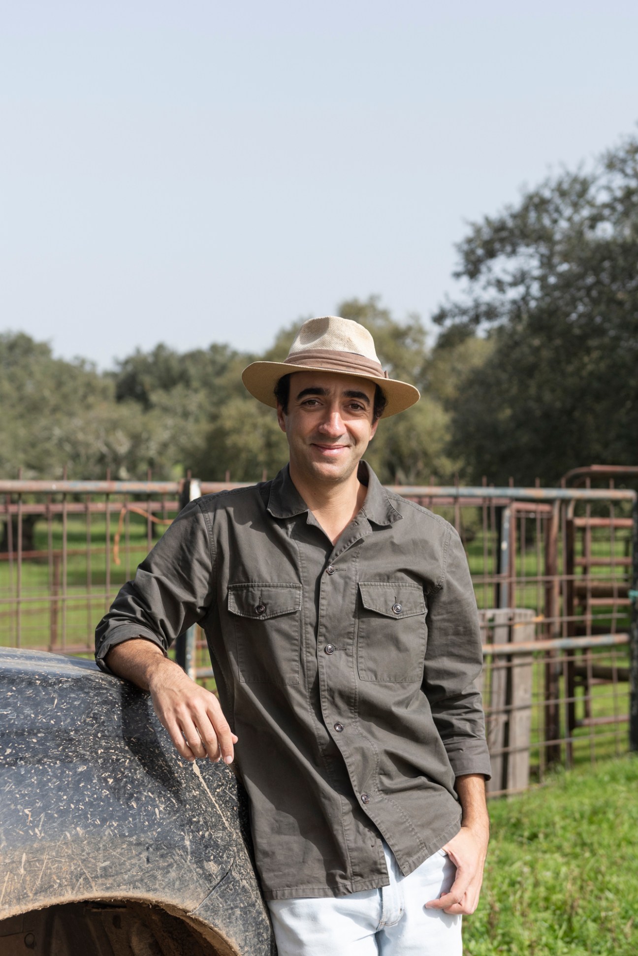 Francisco Alves, owner of Porcus Natura farm, standing outdoors in work clothes and hat