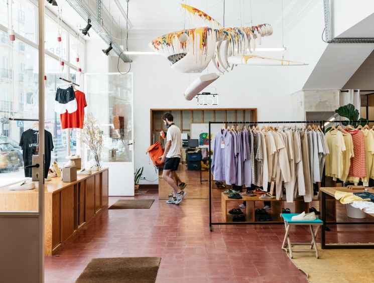 Bright spacious interior of 1351 store with clothing racks, natural lighting and minimalist design