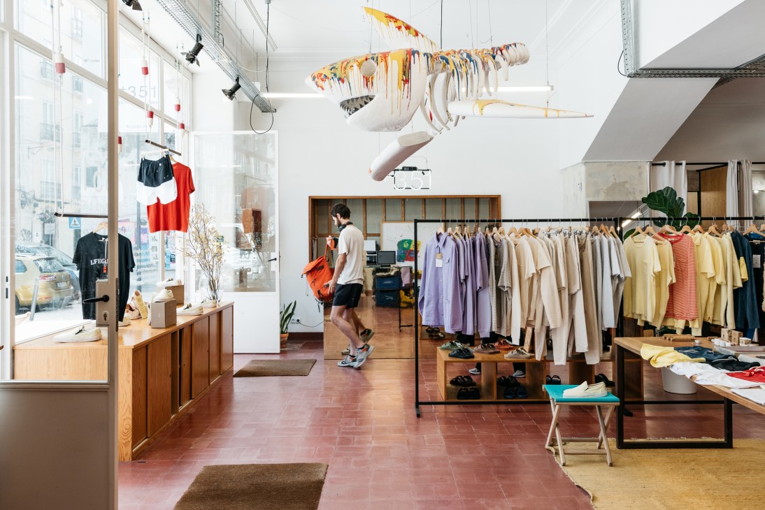 Bright spacious interior of 1351 store with clothing racks, natural lighting and minimalist design