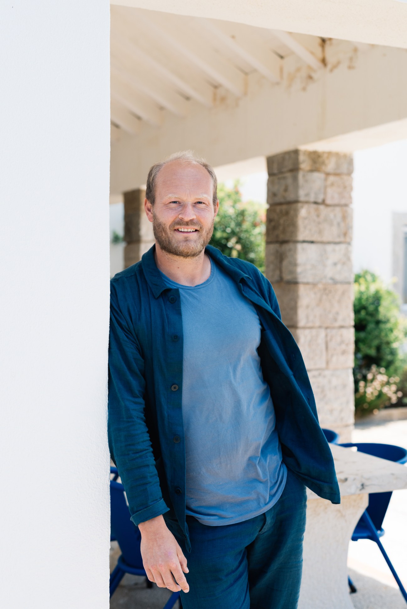 Christian Kraus, founder and owner of apartment complex The Outpost, Colares, smiles under a modern covered structure.