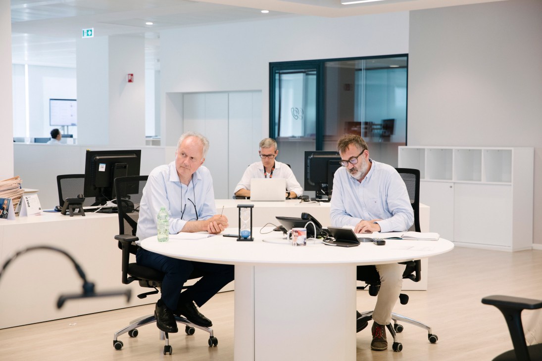 Editorial meeting in progress with staff gathered around table