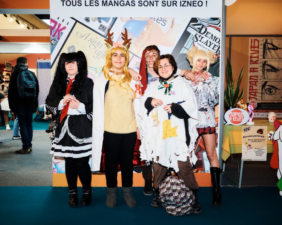 Five students in anime and manga character costumes posing together at the Angoulême festival