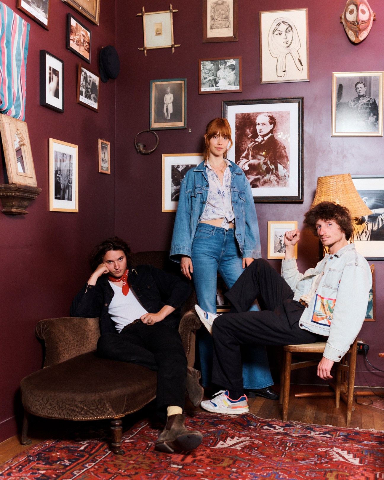Christopher Willatt, Julia Johansen and Lewis Lazar of Oracle Sisters in a room with burgundy walls and framed artwork