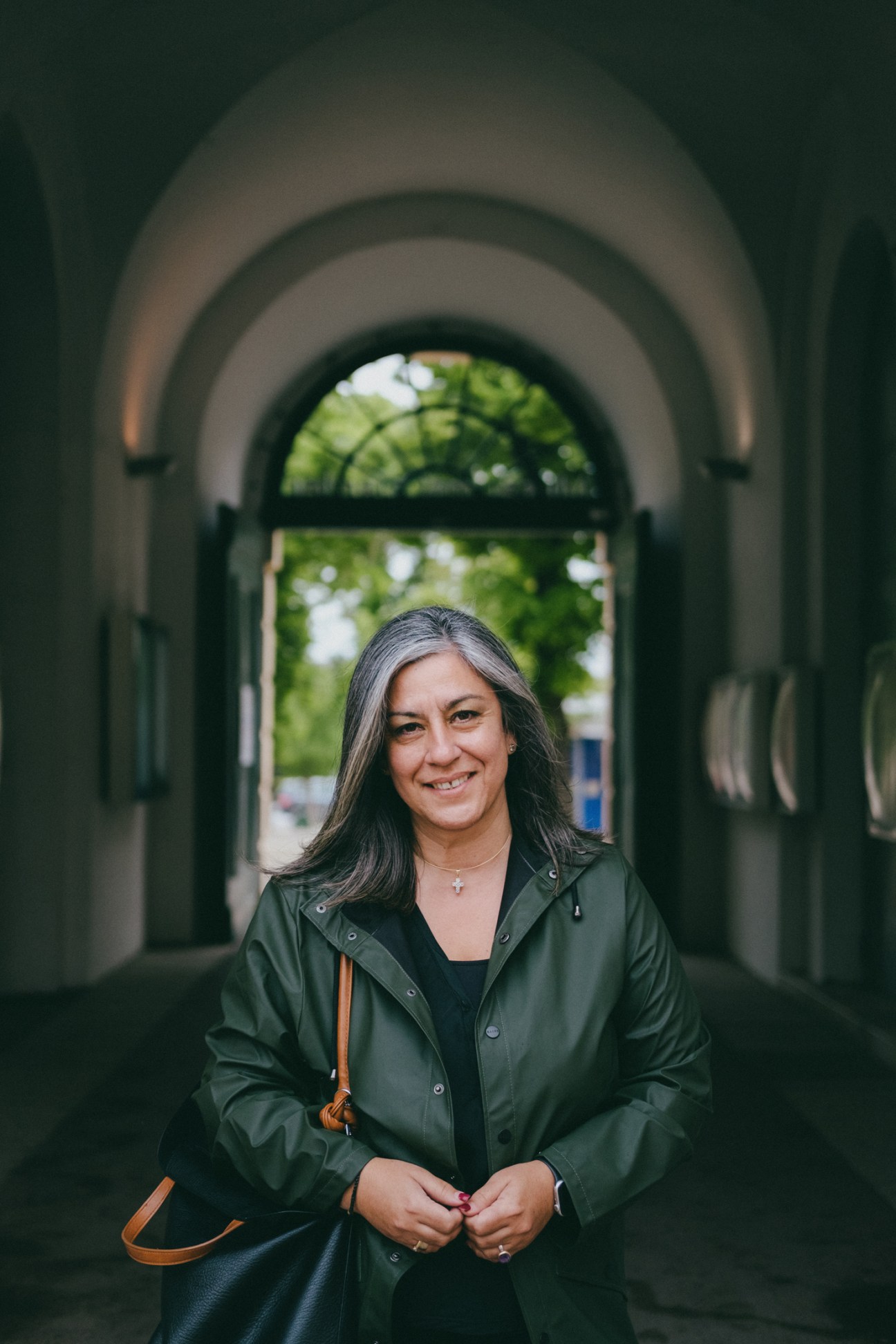 Maria Vassilakou standing in an arched passageway wearing a green coat