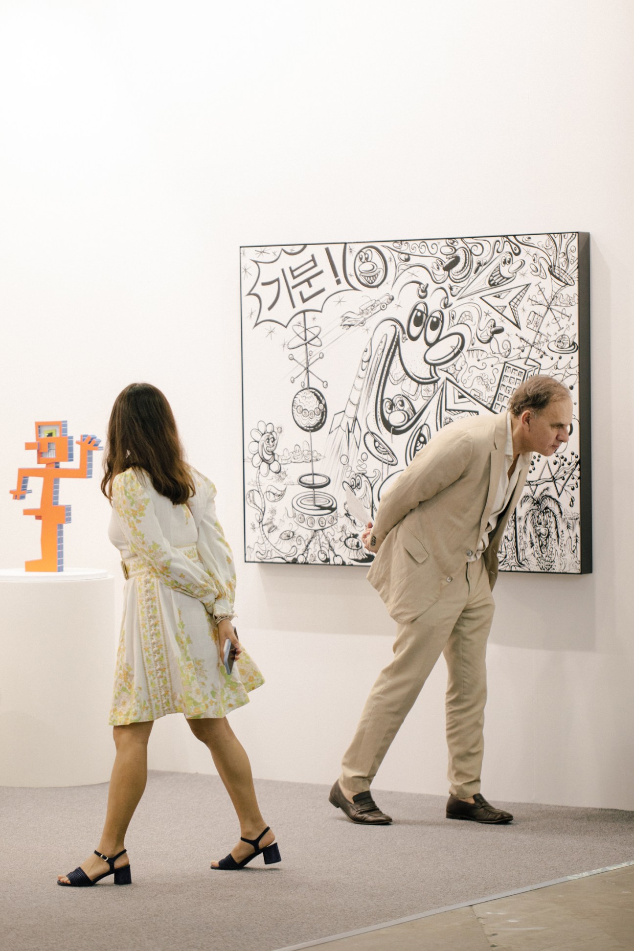 Art collectors and visitors browsing contemporary artworks at the bustling Art SG fair venue