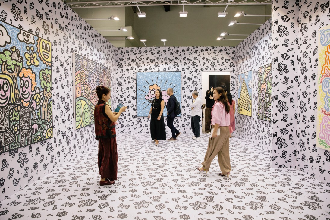 Immersive art installation with black and white patterned walls and visitors exploring the interactive gallery space