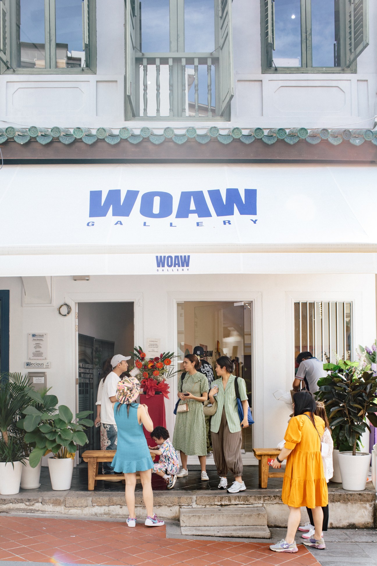 WOAW Gallery Singapore shophouse exterior with visitors gathered outside the heritage building entrance