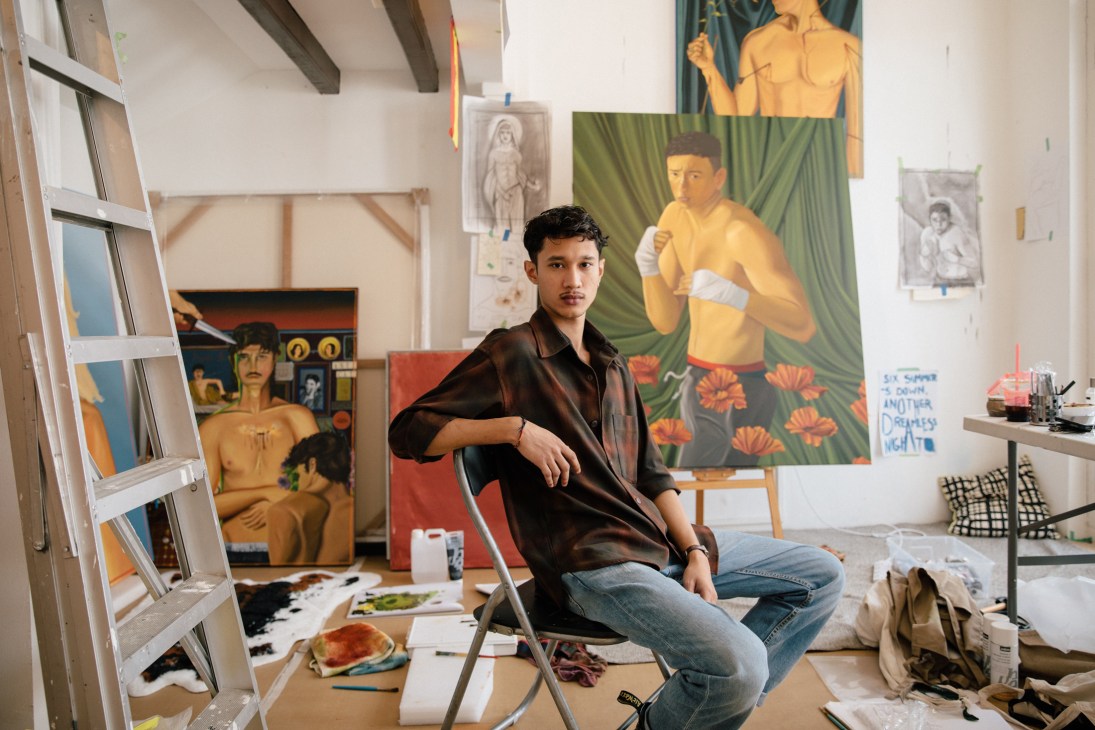 Israfil Ridhwan in his studio at Cuturi Gallery surrounded by neo-expressionist oil paintings and art supplies