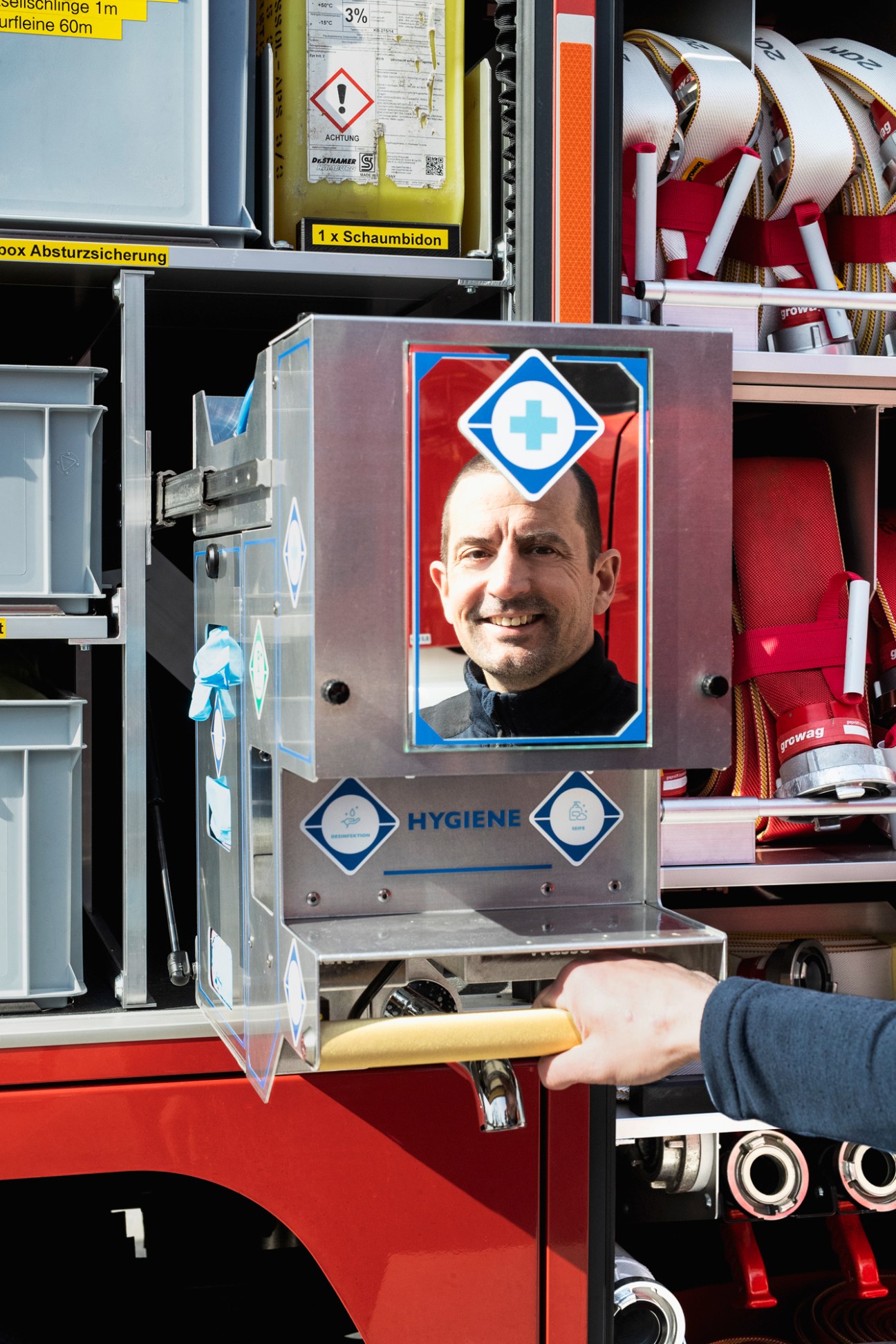 Pull-out hygiene kit with water tap, hand dryer and eye shower equipment on a Brändle fire engine