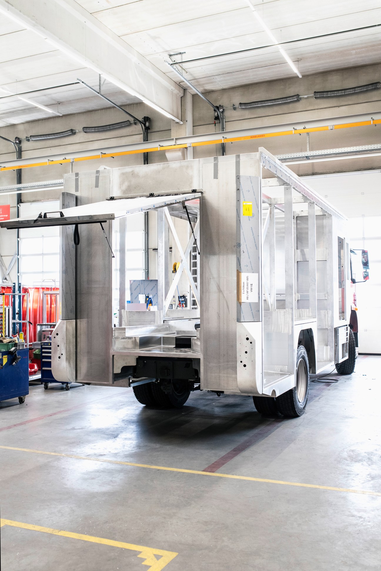 Fire engine in production at Brändle's manufacturing facility with workers assembling components