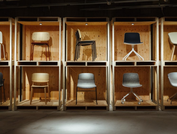 05:00 Claude responded: Various modern chair designs displayed individually in illuminated wooden cubicle shelves in a furniture showroom. Various modern chair designs displayed individually in illuminated wooden cubicle shelves in a furniture showroom.