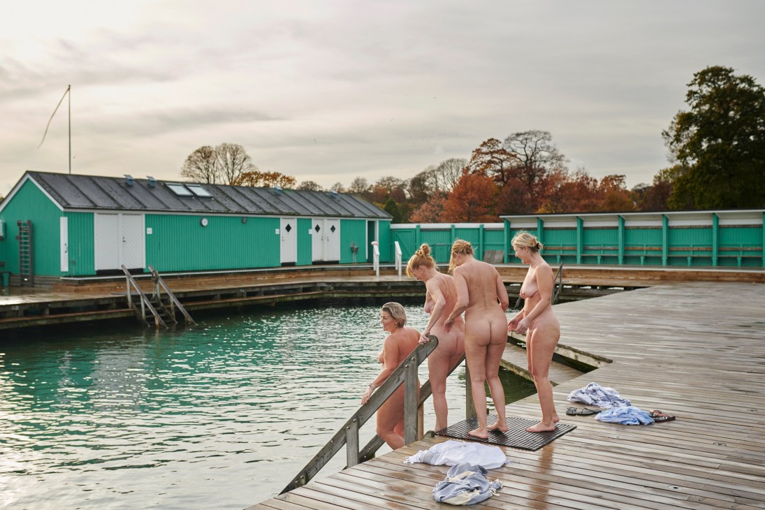 Women prepare to enter the water at Charlottenlund Søbad winter-bathing club in Denmark.
