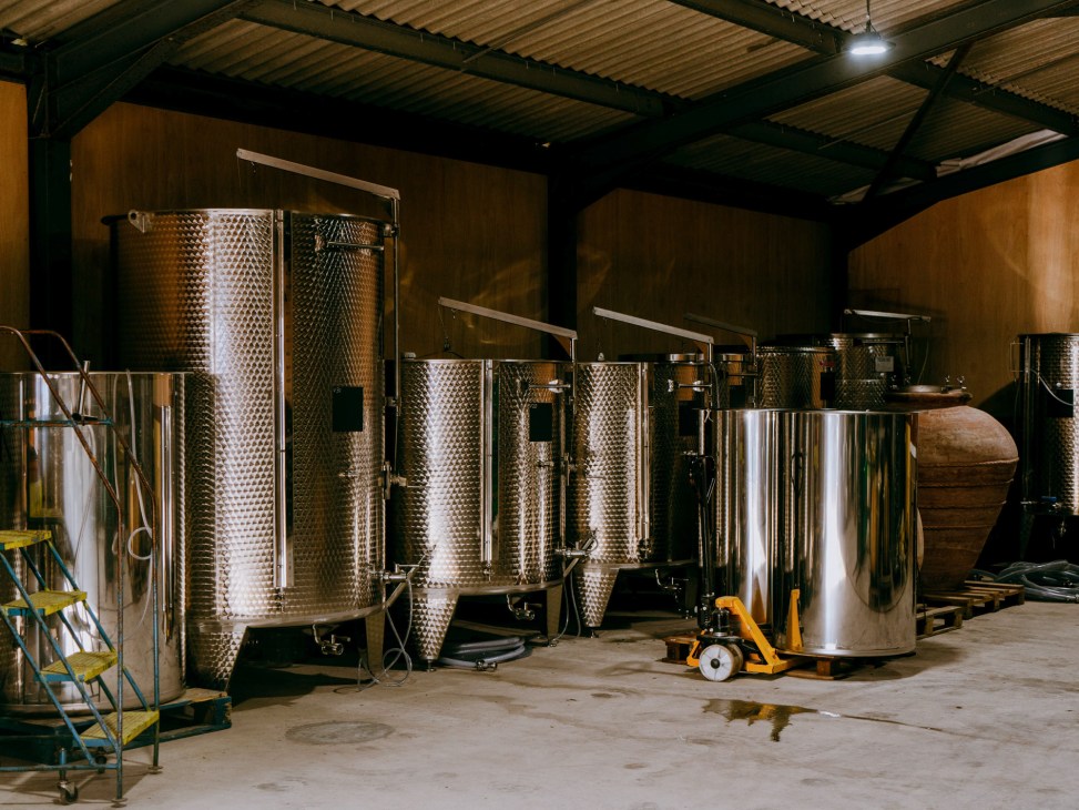 Stainless steel fermentation tanks and wine-making equipment in industrial winery facility