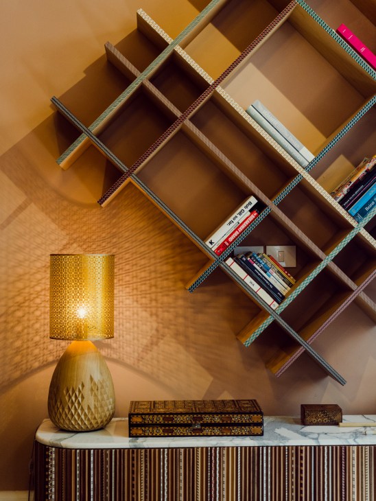 Nada Debs furniture designer at her studio workspace with neo-Arabian design pieces.