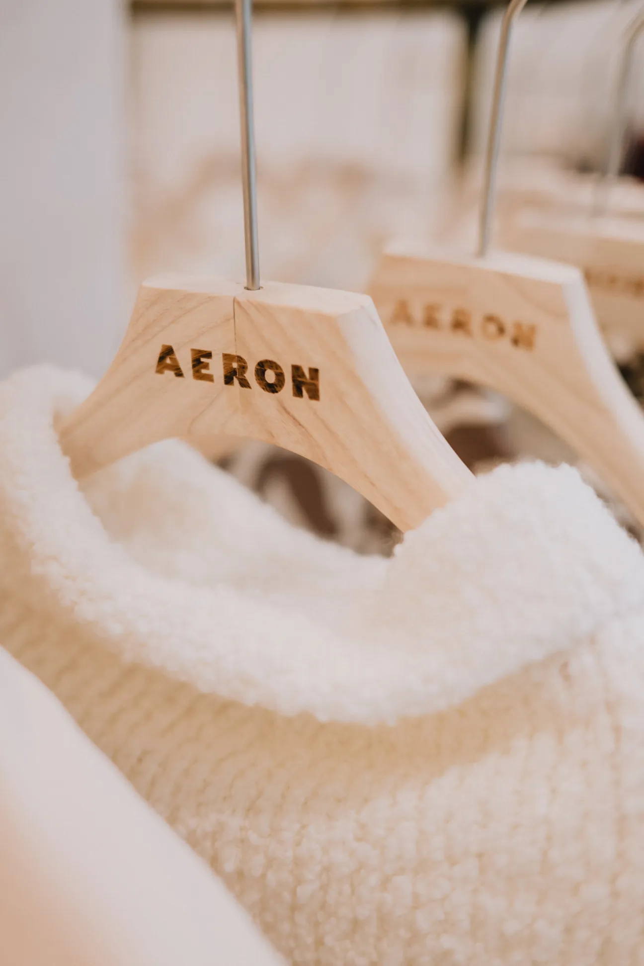 Close-up of Aeron blazer with signature A-shaped buttons and peaked lapels