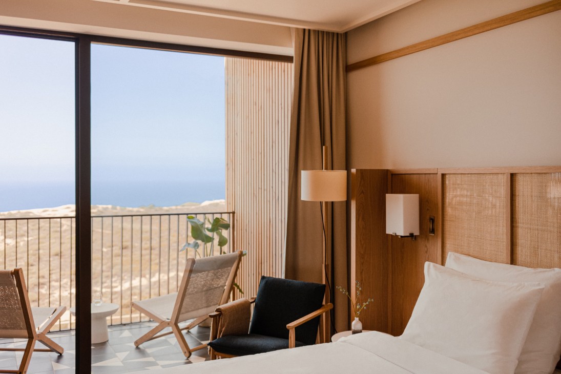 Aethos Ericeira hotel room with ocean view terrace featuring modern furnishings and panoramic Atlantic coastline views