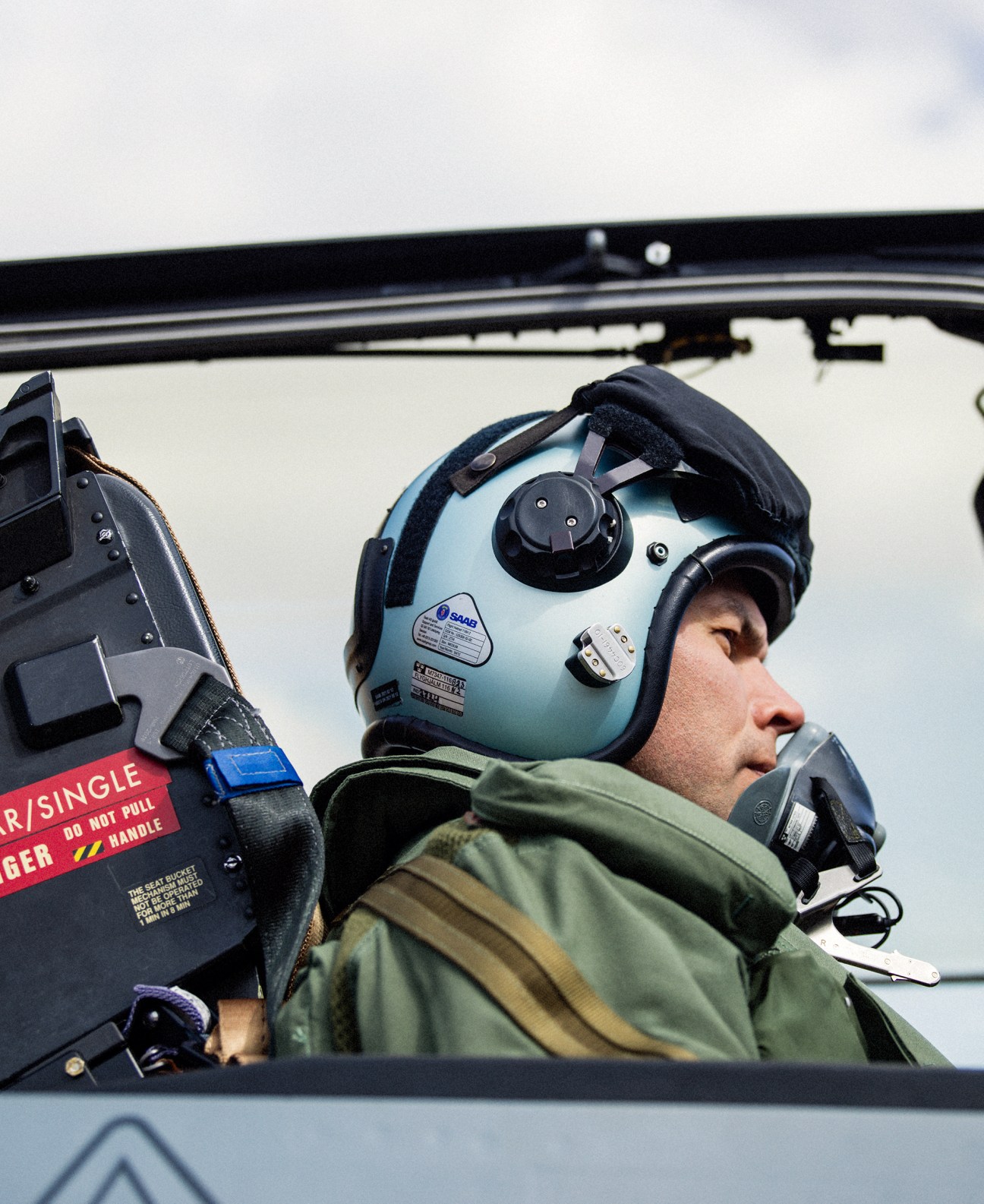 Marcus Wandt in flight helmet and suit sitting in aircraft cockpit preparing for takeoff