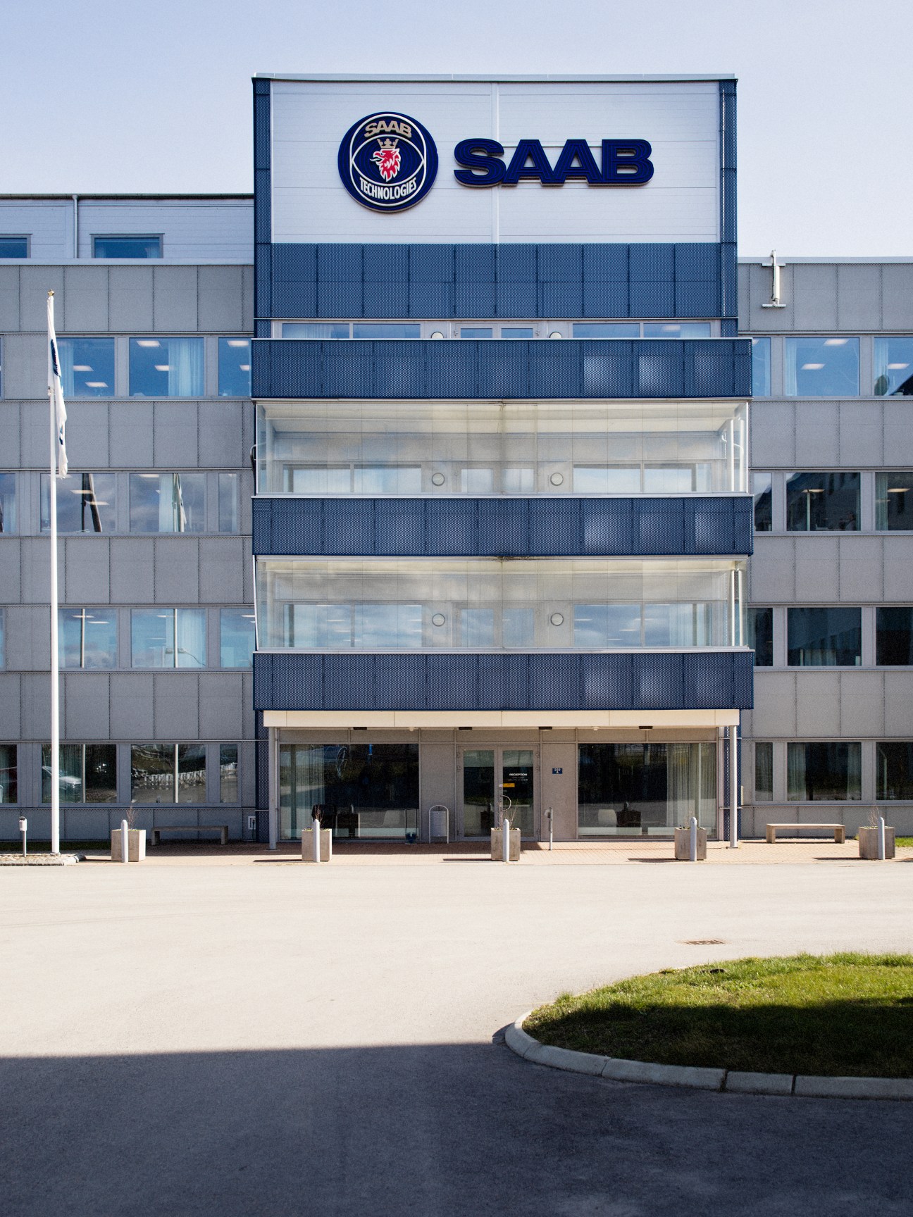 Modern office building with Saab Technologies logo and branding on the facade