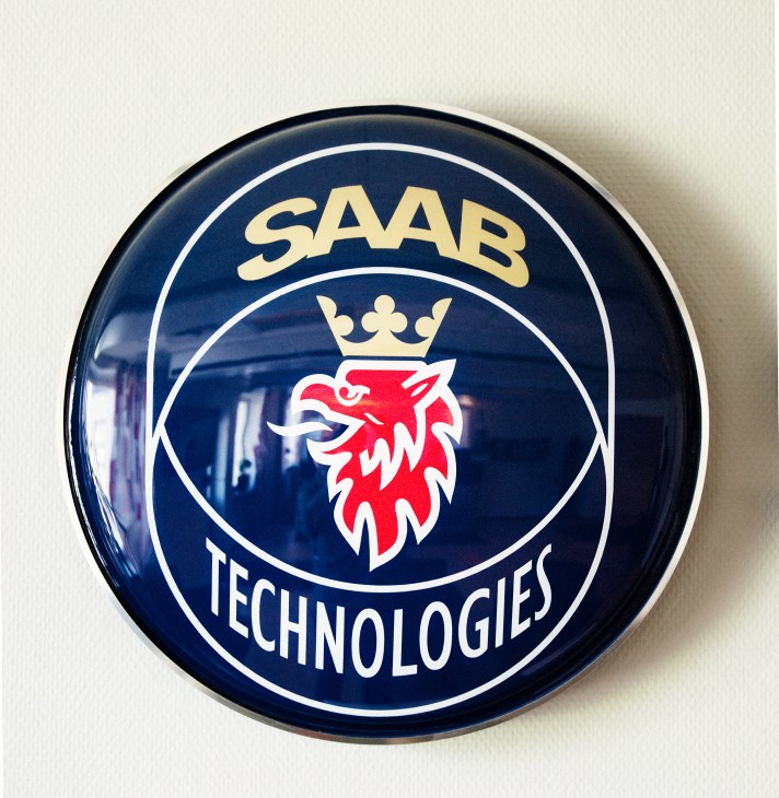 Close-up of a Saab Technologies employee identification badge worn by a worker at the facility