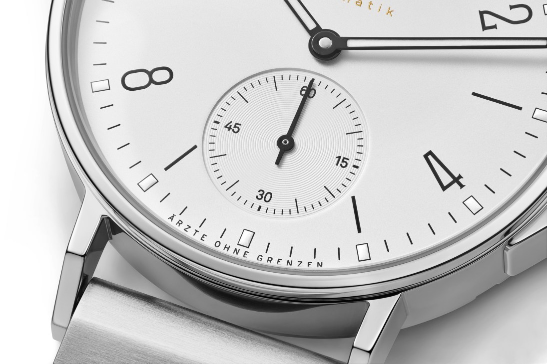 Close-up of AHOI neomatik watch face with white dial, subsidiary seconds dial, and steel case.