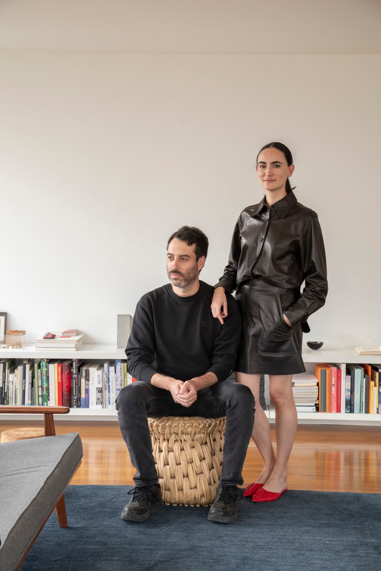 Architects Mauricio Mesta and Frida Escobedo in modern apartment interior with bookshelves