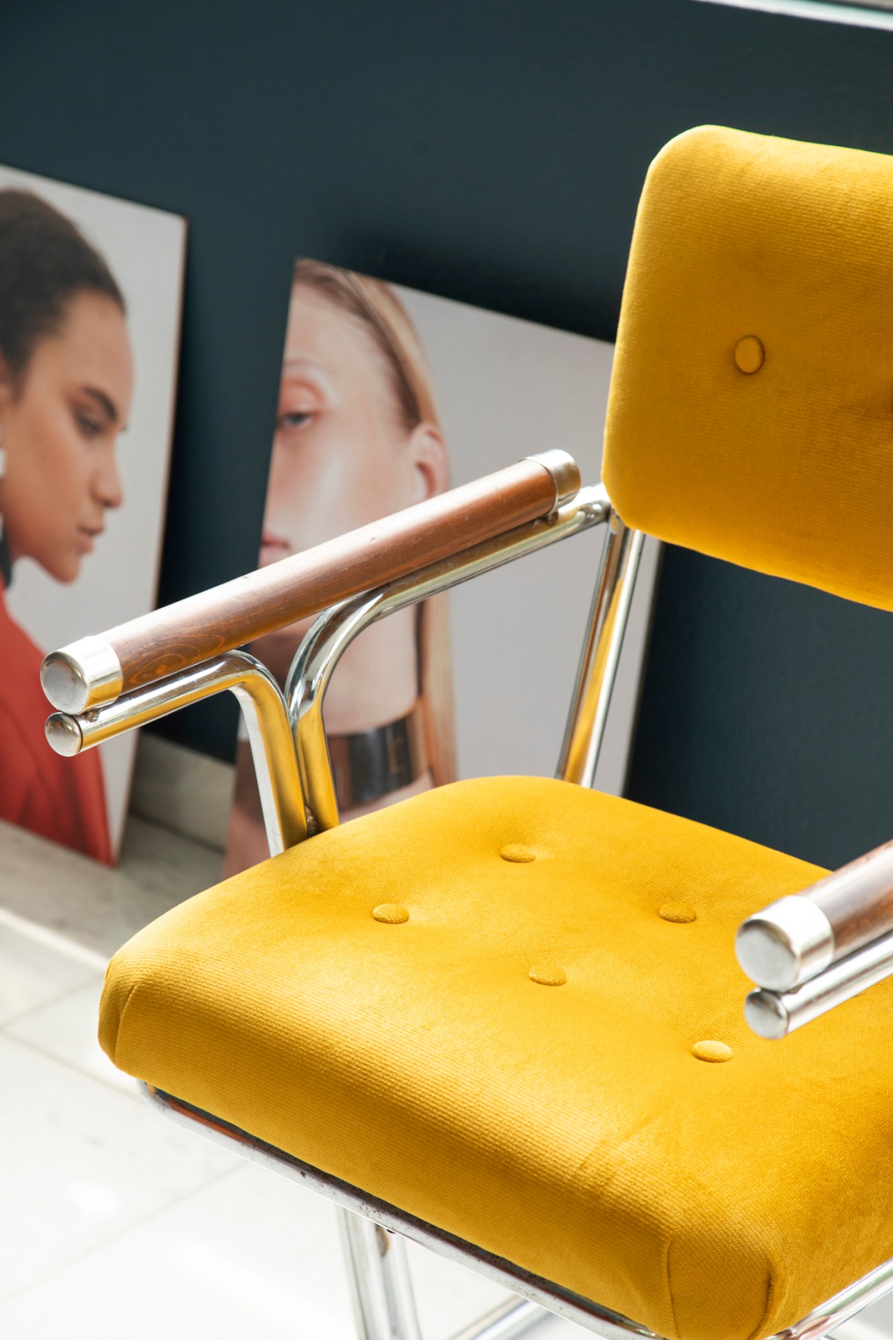Yellow upholstered chair with chrome and wood frame in jewellery showroom