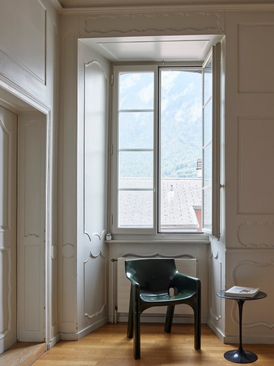Mountain landscape view through apartment windows showing Alpine peaks