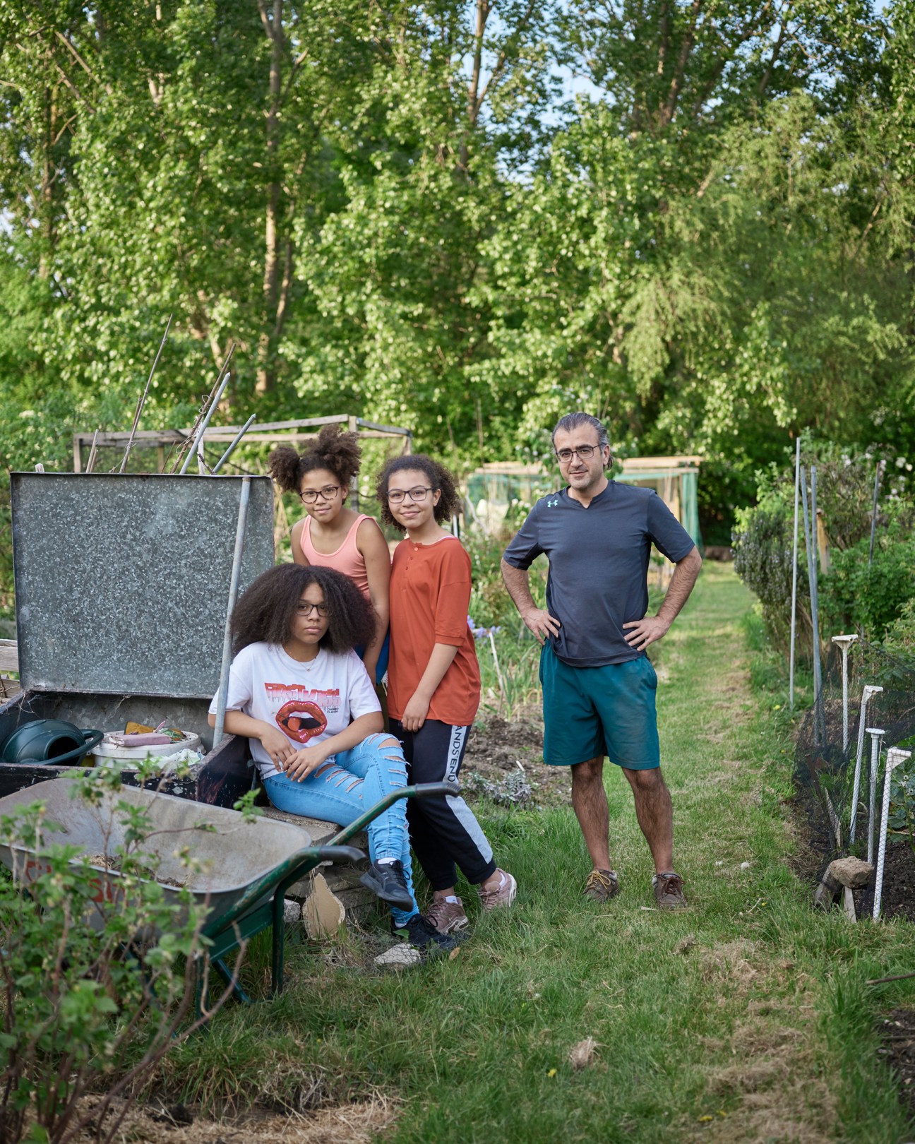 Tariq Khatri and his three daughters posing together at Gun Site Allotments garden