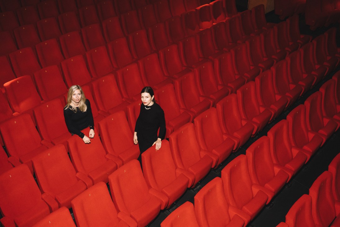 Film-maker Jessica Hausner and musician Anja Plaschg sit among empty red cinema seats.