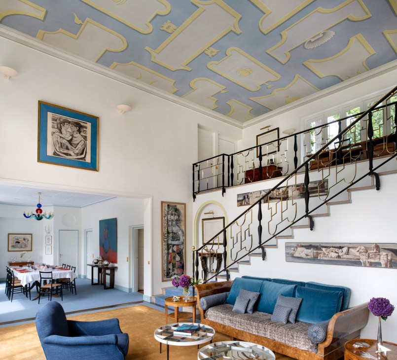 Wide view of the double-height living room showing the Palladian-inspired ceiling with yellow and blue motifs