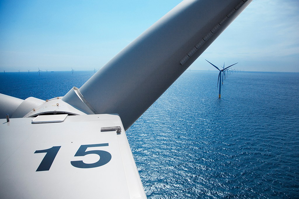 View from inside wind turbine nacelle showing offshore wind farm with number 15 visible on turbine housing