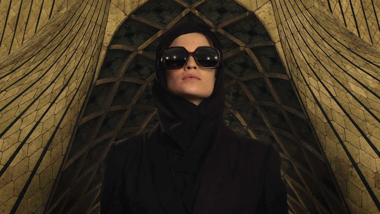 Woman in black hijab and sunglasses against geometric golden background for Tehran TV series
