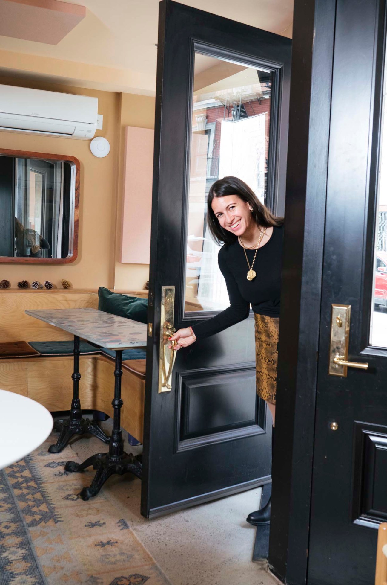 Ariel Arce, hospitality entrepreneur, standing in a doorway of one of her New York venues.