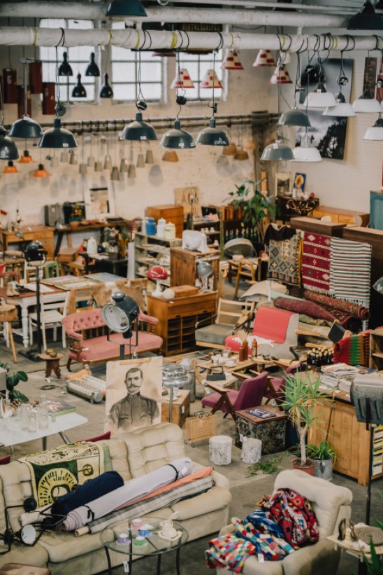 Interior of Artkraft showroom with mid-century furniture under large industrial lamps