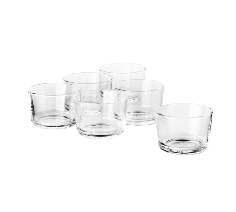 Five clear glass tumblers arranged on white background