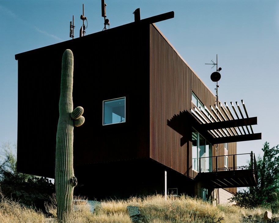 Angular modernist house built into mountainside with dramatic geometric forms