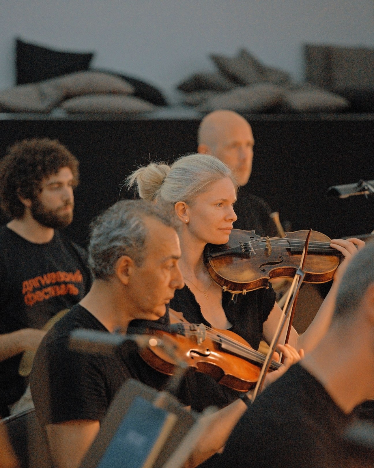 Violinists from MusicAeterna orchestra during rehearsal session