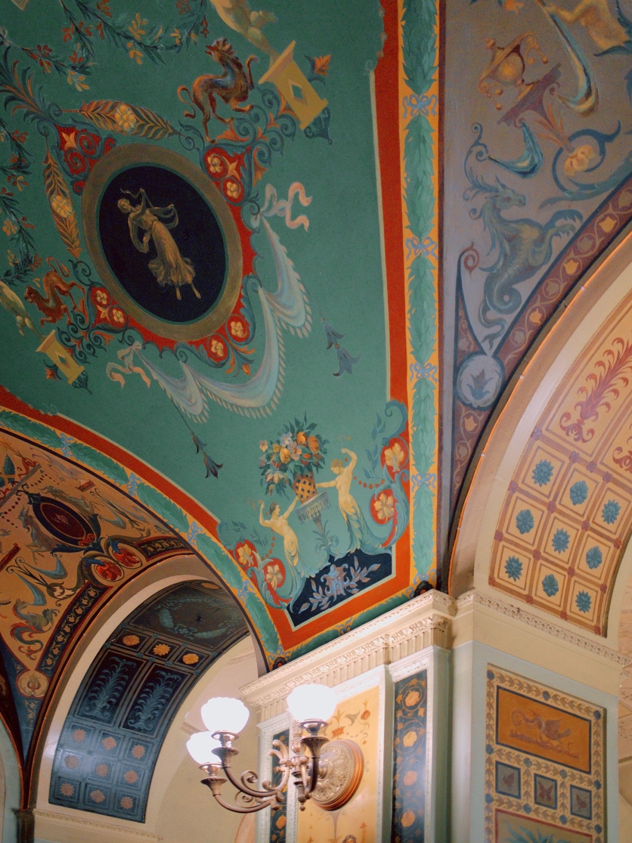 Ornate painted ceiling with elaborate decorative motifs, classical figures, and intricate architectural details in Dom Radio foyer