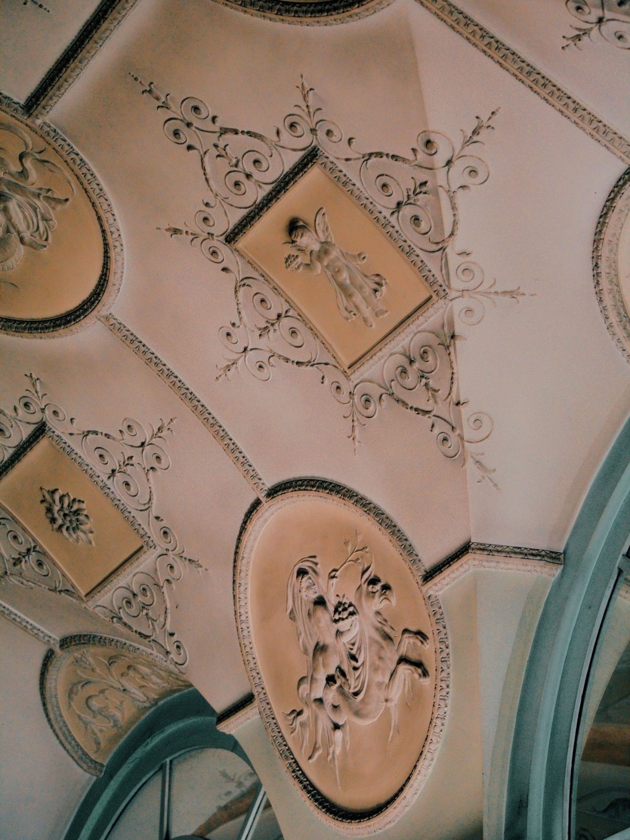 Ornate ceiling with decorative bas-relief sculptures and scrollwork in Dom Radio's foyer