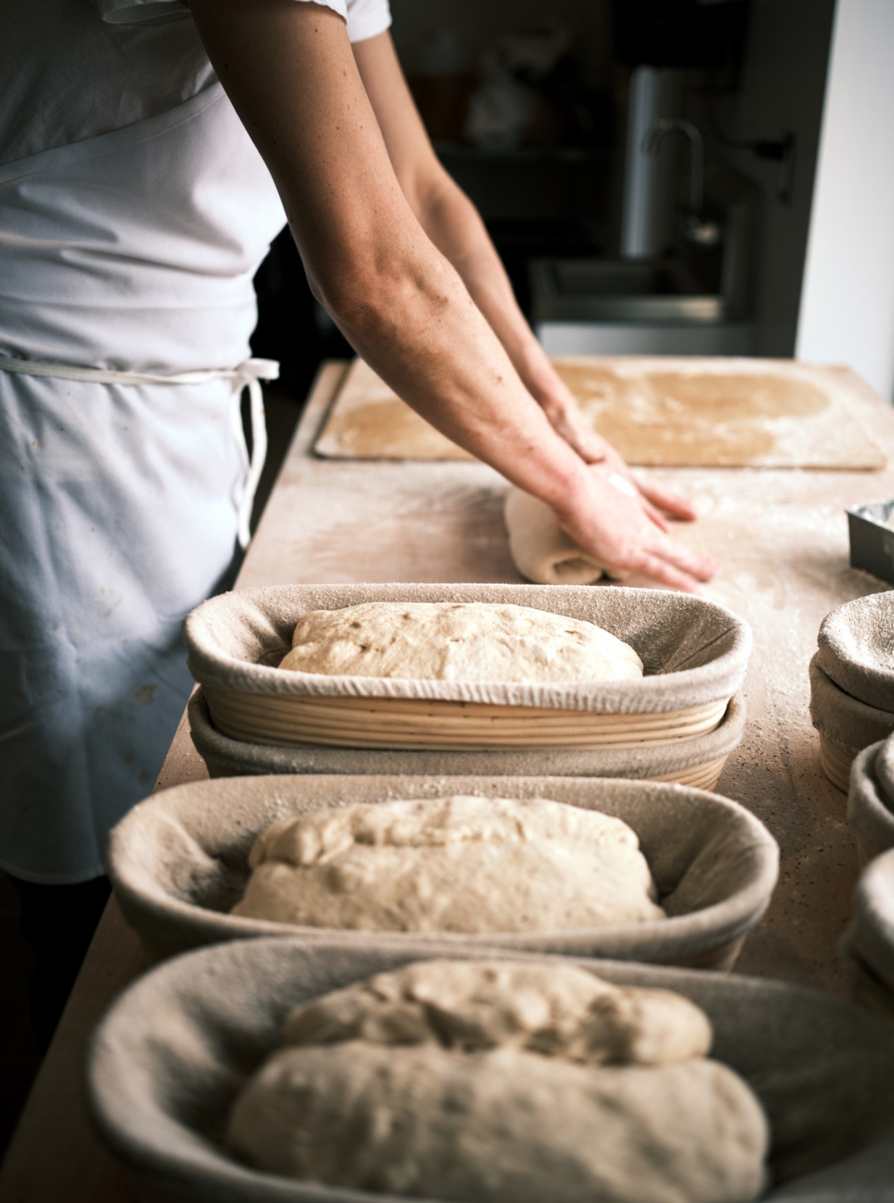 Baker working with dough at RPM Bakehouse kitchen