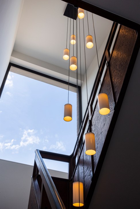Interior hallway with period lighting fixtures and wood-panelled walls demonstrating original architectural details
