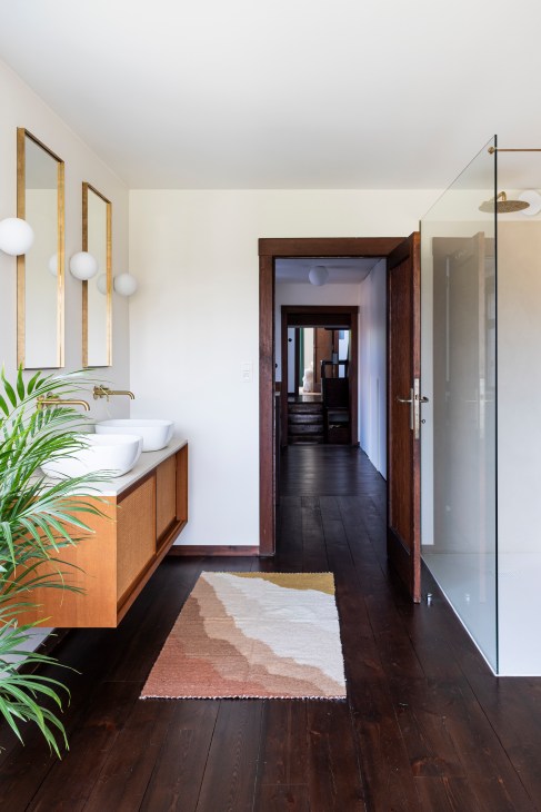 Large bathroom featuring solid yellow terrazzo bathtub and expanded layout with corner window