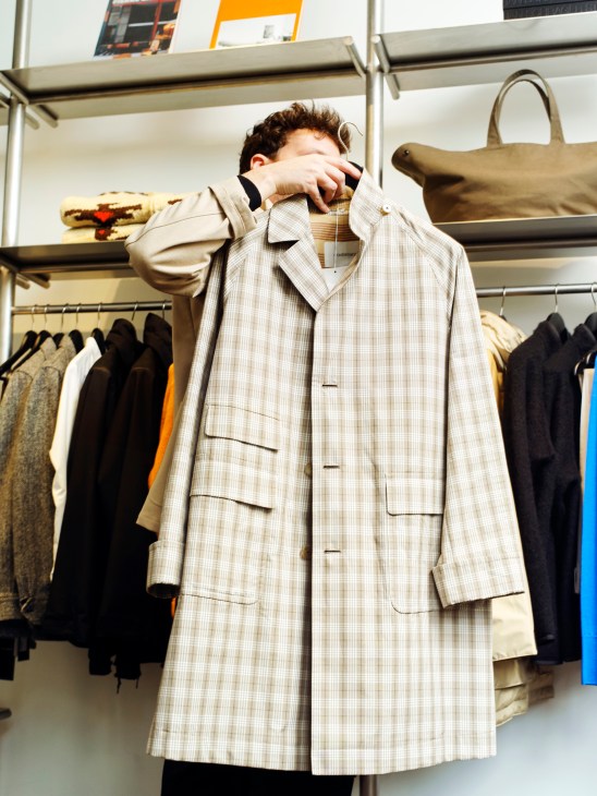 Close-up of a wool coat hanging in Beige Habilleur Paris store