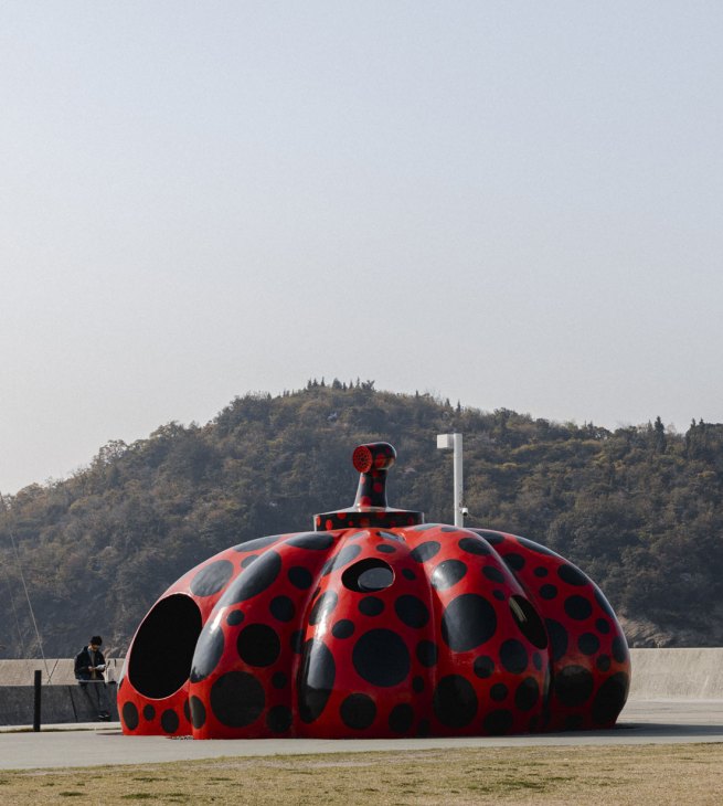 Red polka-dotted pumpkin sculpture by Yayoi Kusama on Naoshima island