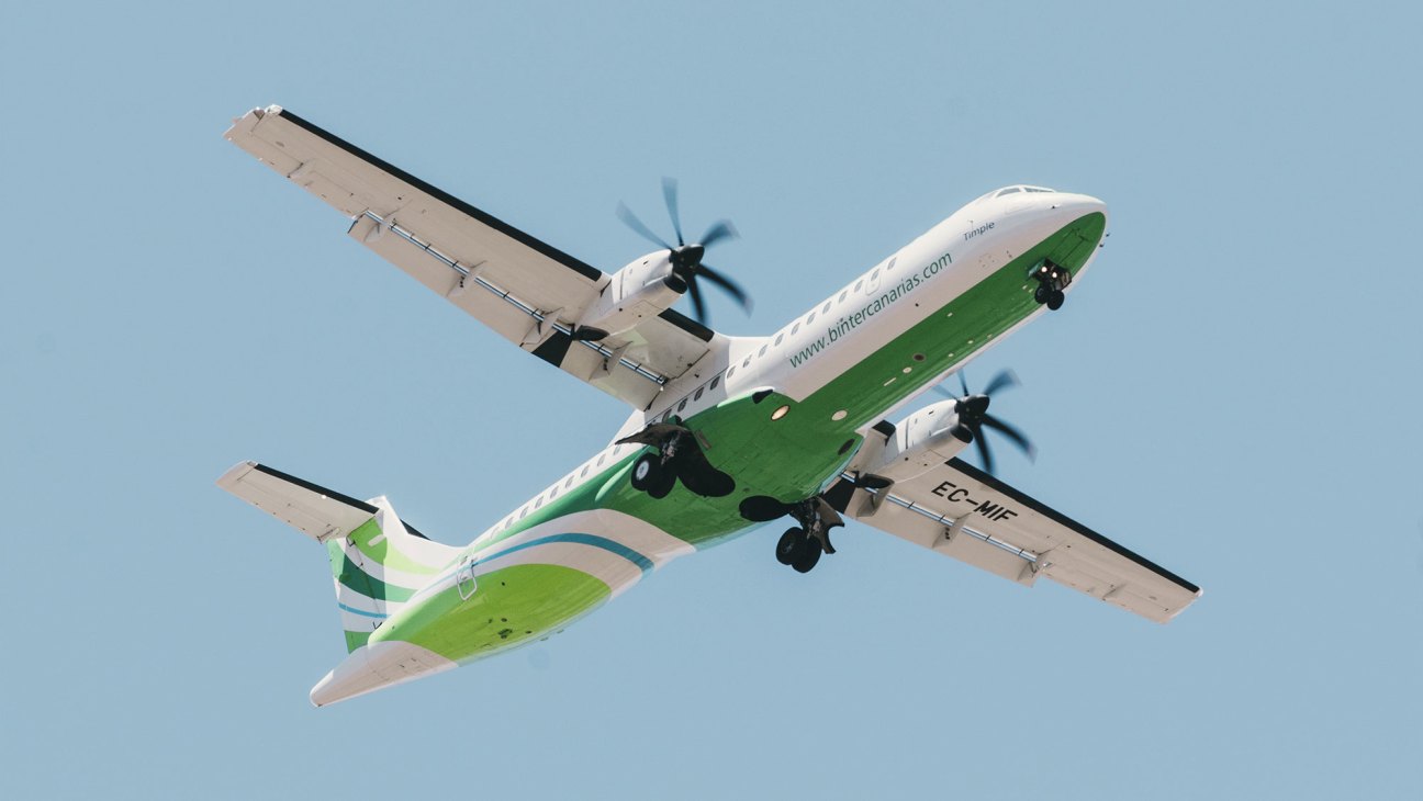 Binter Canarias aircraft in flight against blue sky