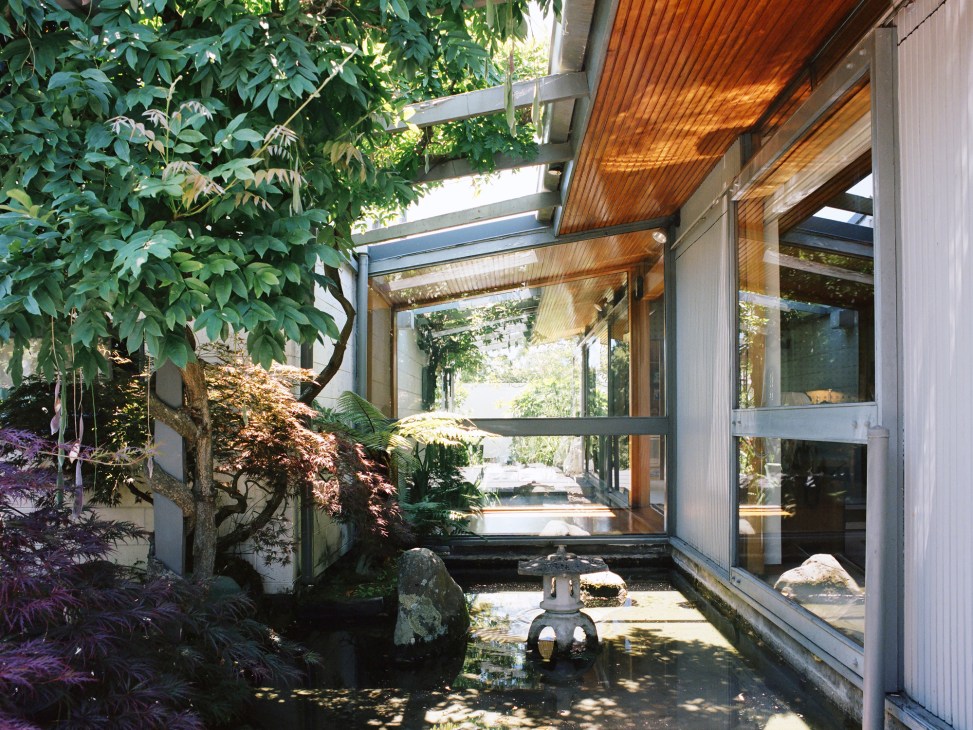 Copper gutters discharge directly over pools in Japanese-inspired courtyard garden with water features