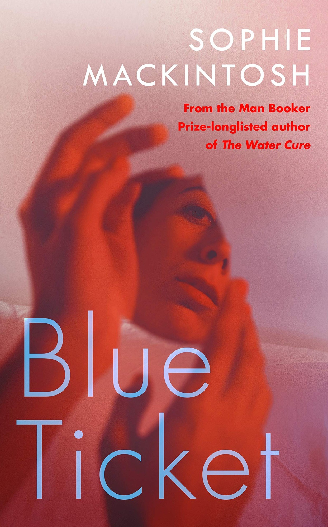 Book cover of Blue Ticket by Sophie Mackintosh showing a woman's face in red and pink tones