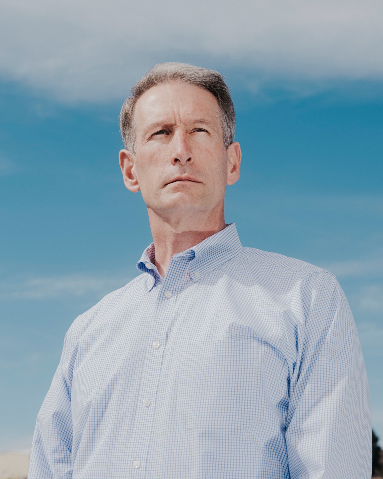 Troy Follak, Boom's chief engineer, standing outdoors in a light blue checkered shirt