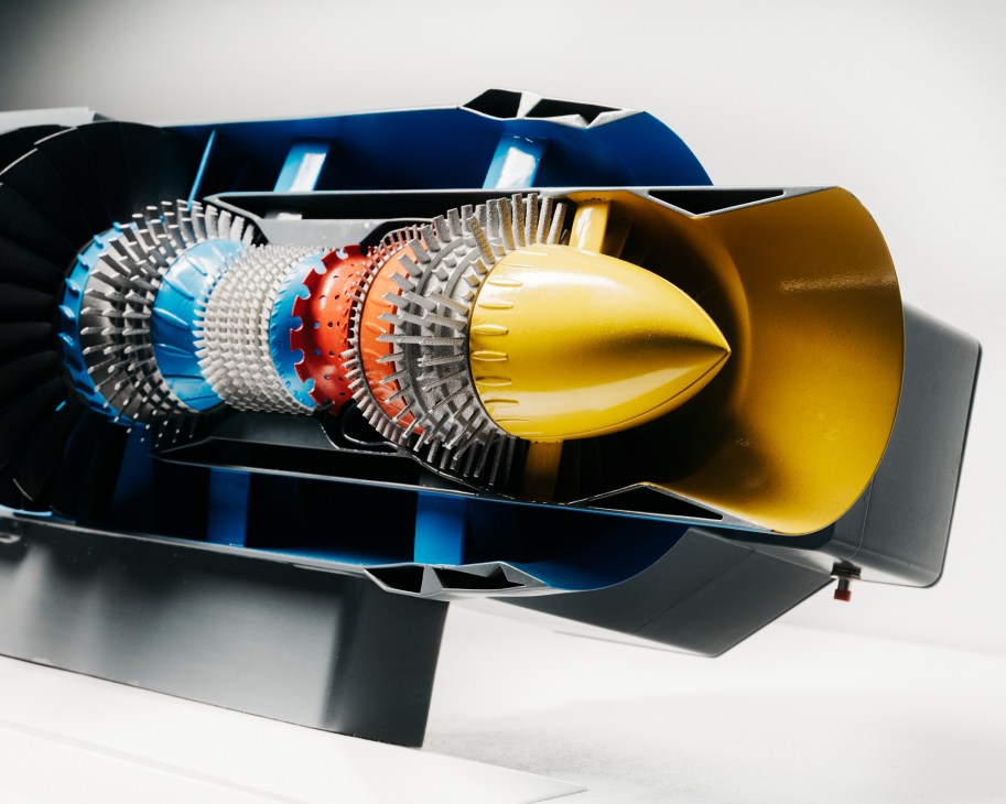 Cross-section view of a jet engine showing internal components including turbine blades and combustion chamber