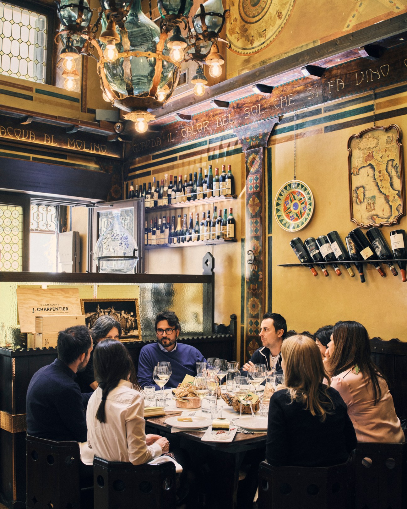 Animated discussion between wine producers during lunch at Antica Bottega del Vino